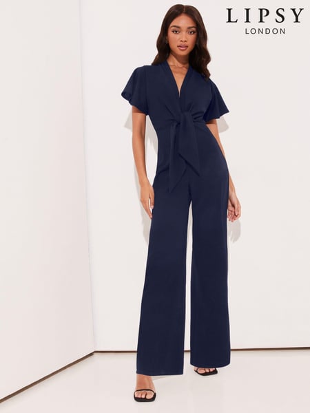 Lipsy Navy Blue Flutter Sleeve V Neck Tie Front Wide Leg Jumpsuit (E76569) | € 57