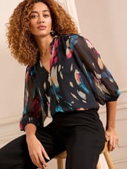 Love & Roses Black Abstract Petite Zip Front Mix Sheer Long Sleeve Length Blouse - Image 1 of 4