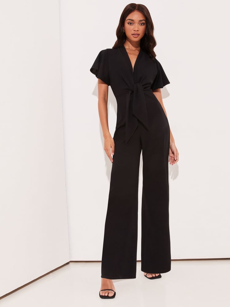 Lipsy Black Flutter Sleeve V Neck Tie Front Wide Leg Jumpsuit - Image 1 of 4 Lipsy Black Flutter Sleeve V Neck Tie Front Wide Leg Jumpsuit - Image 1 of 4